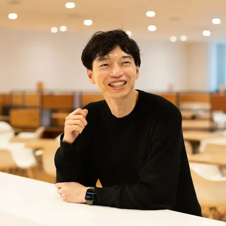 Headshot of Kenji Kawamura smiling at the camera